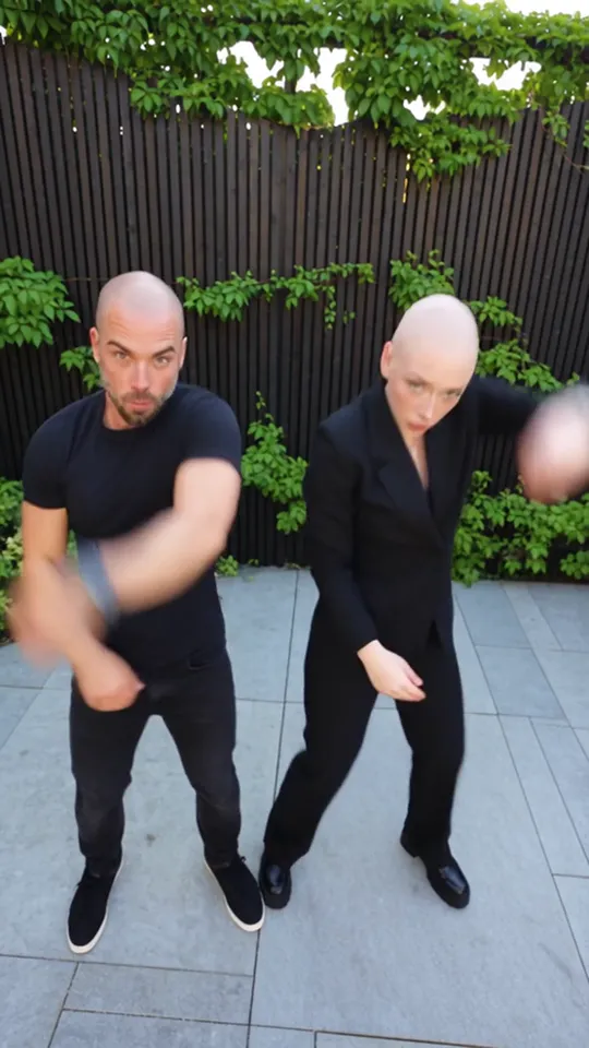 Smalltown Boy AI clip still: both performers dance a hand-jive side by side in the courtyard